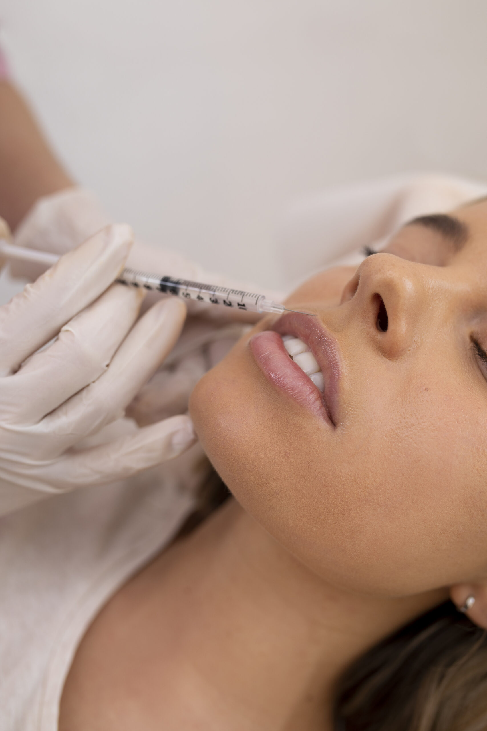 close-up-woman-getting-lip-filler-with-injection